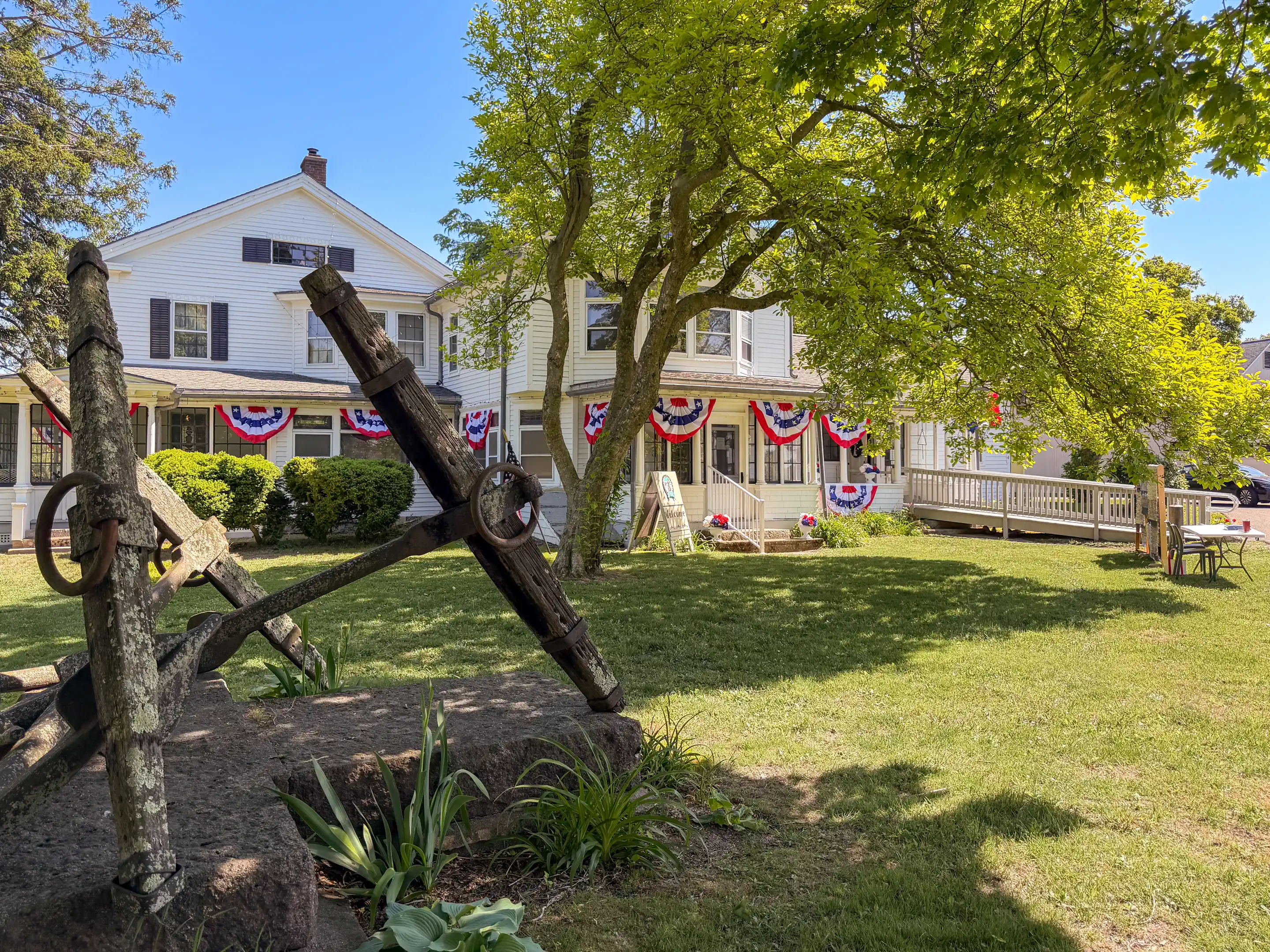 The Boothe Homestead decorated for Opening Day with a historic anchor in the foreground