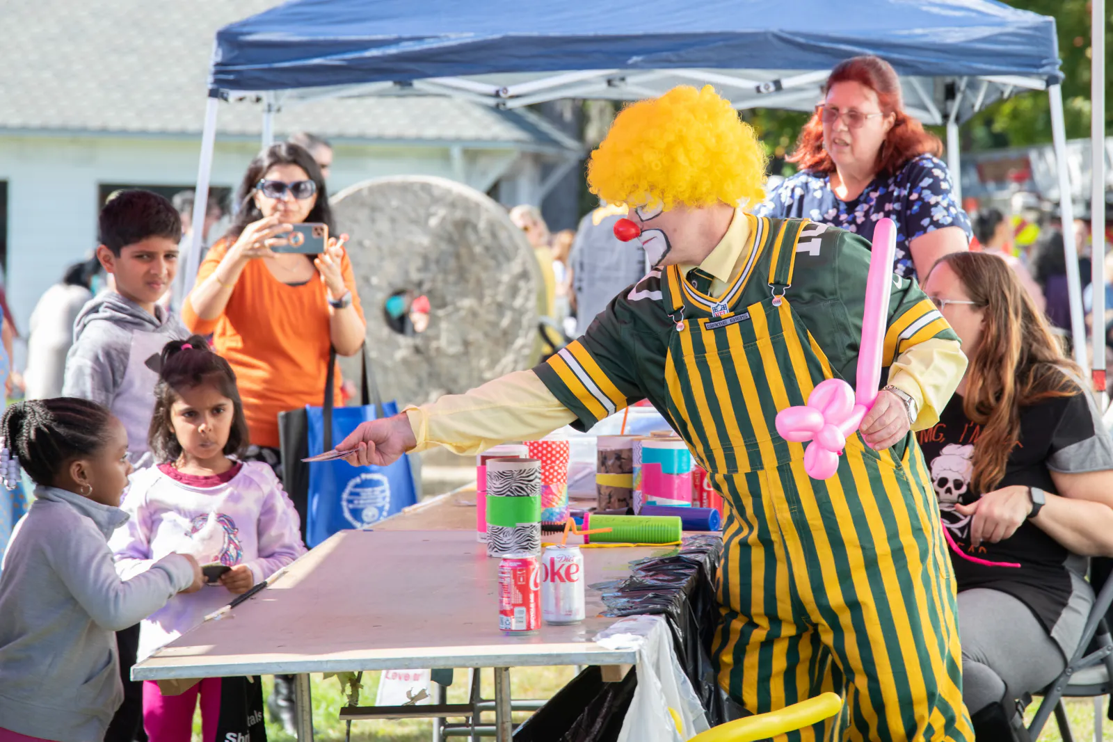 A costumed clown greeting families at the Great Pumpkin Festival