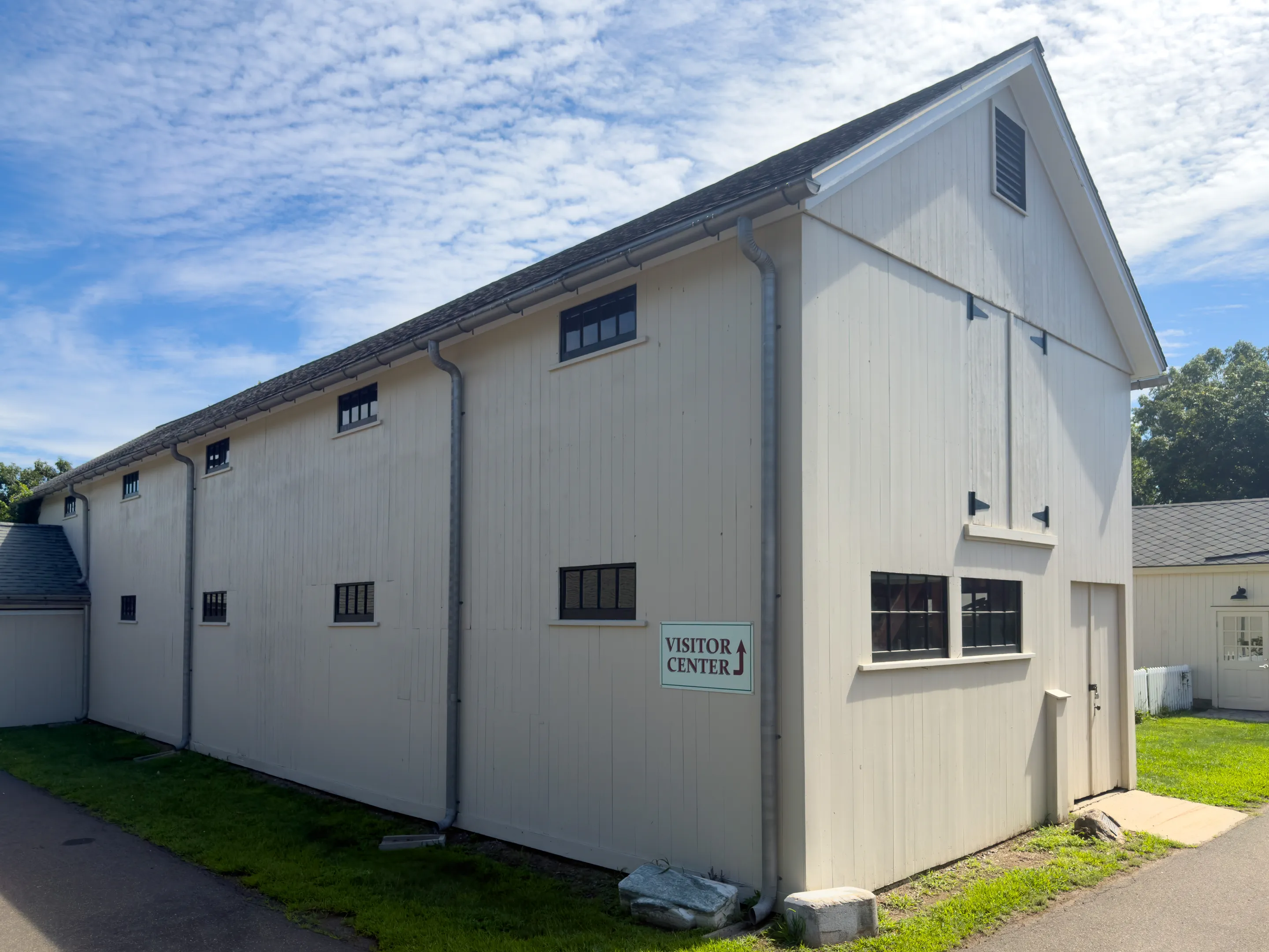 Long white exterior of the former horse barn that houses the Americana Museum