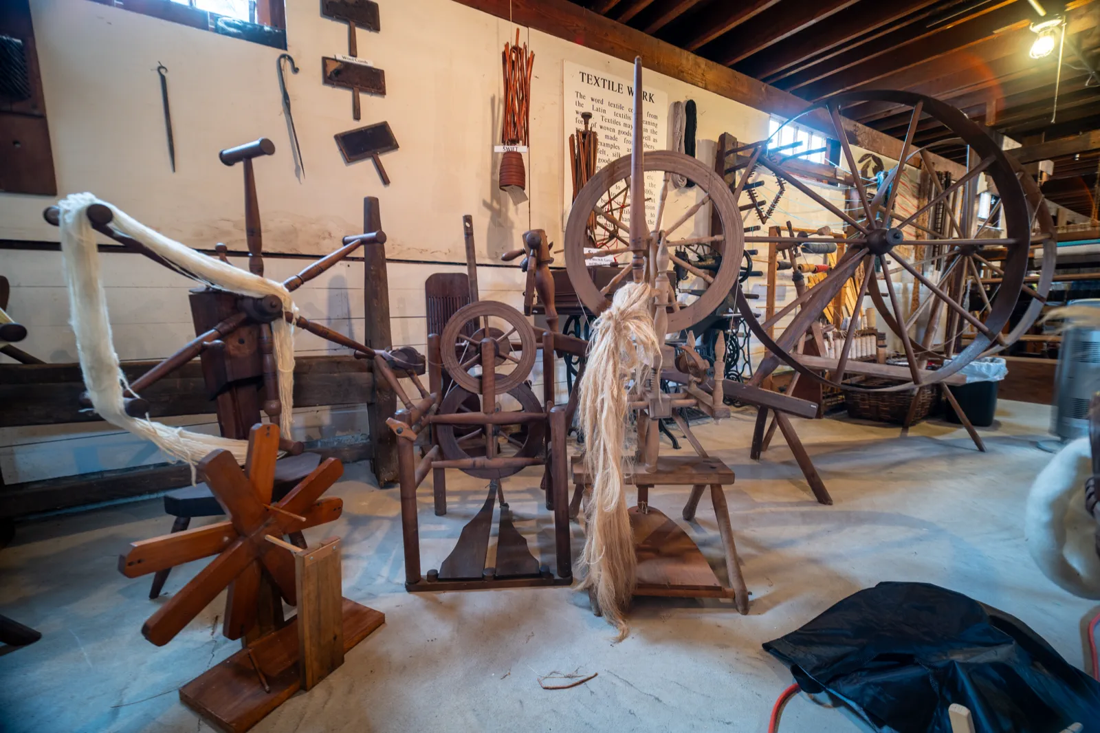 Spinning wheels and textile tools displayed inside the Americana Museum