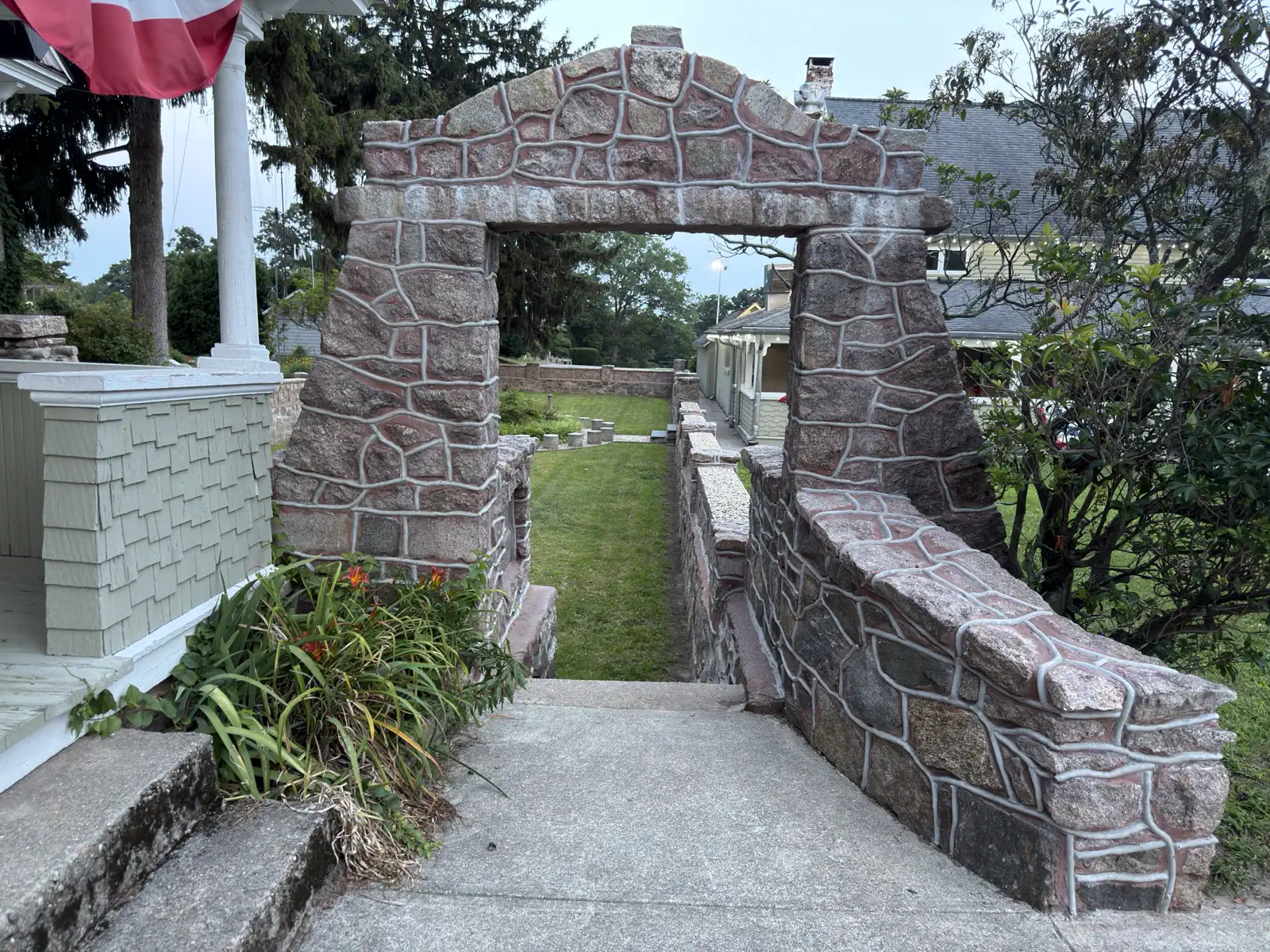 Stone archway and low stone walls at the top of the steps into the Basilica's sunken garden