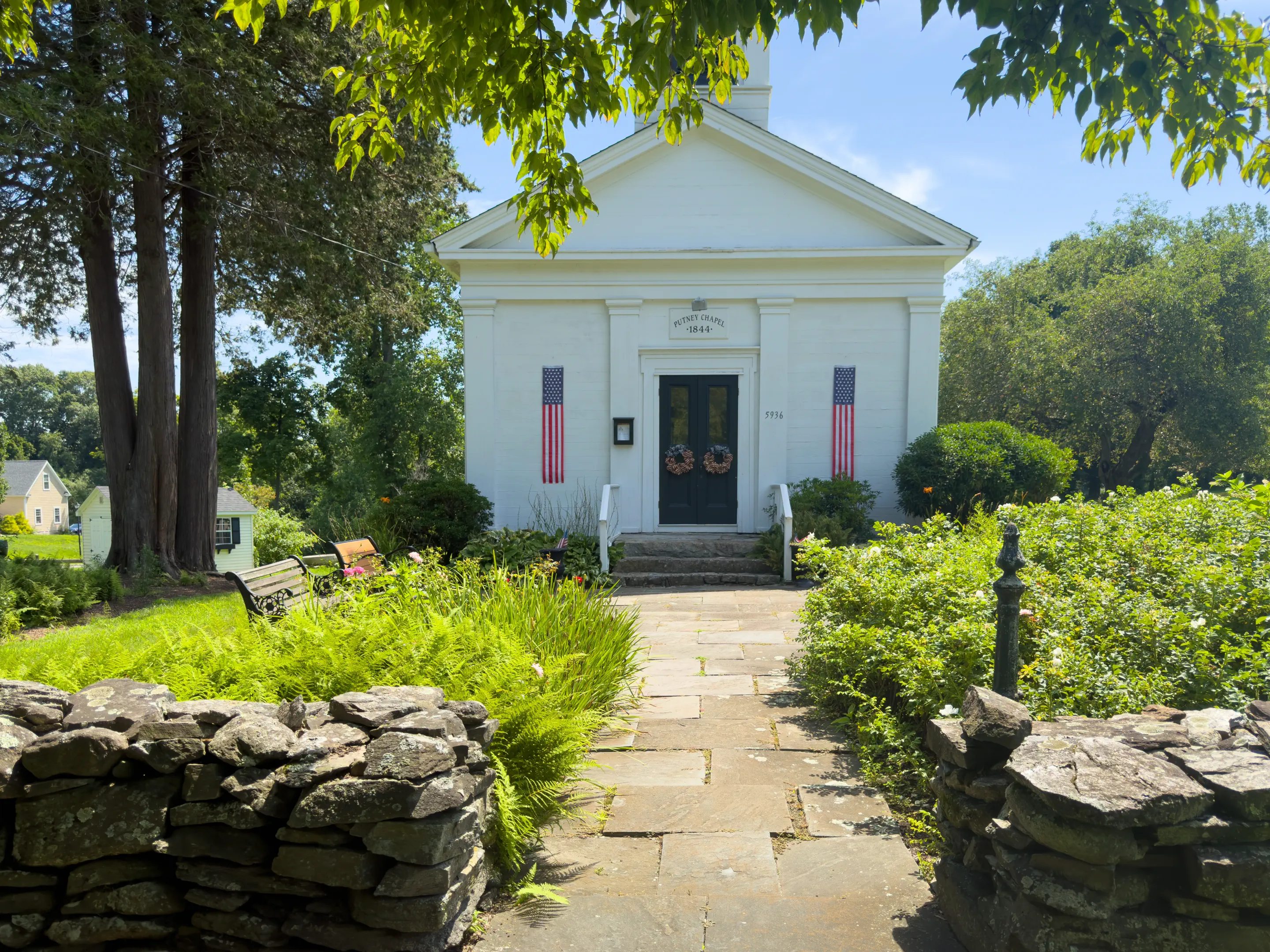 Stone path leading through the garden to the front doors of Putney Chapel
