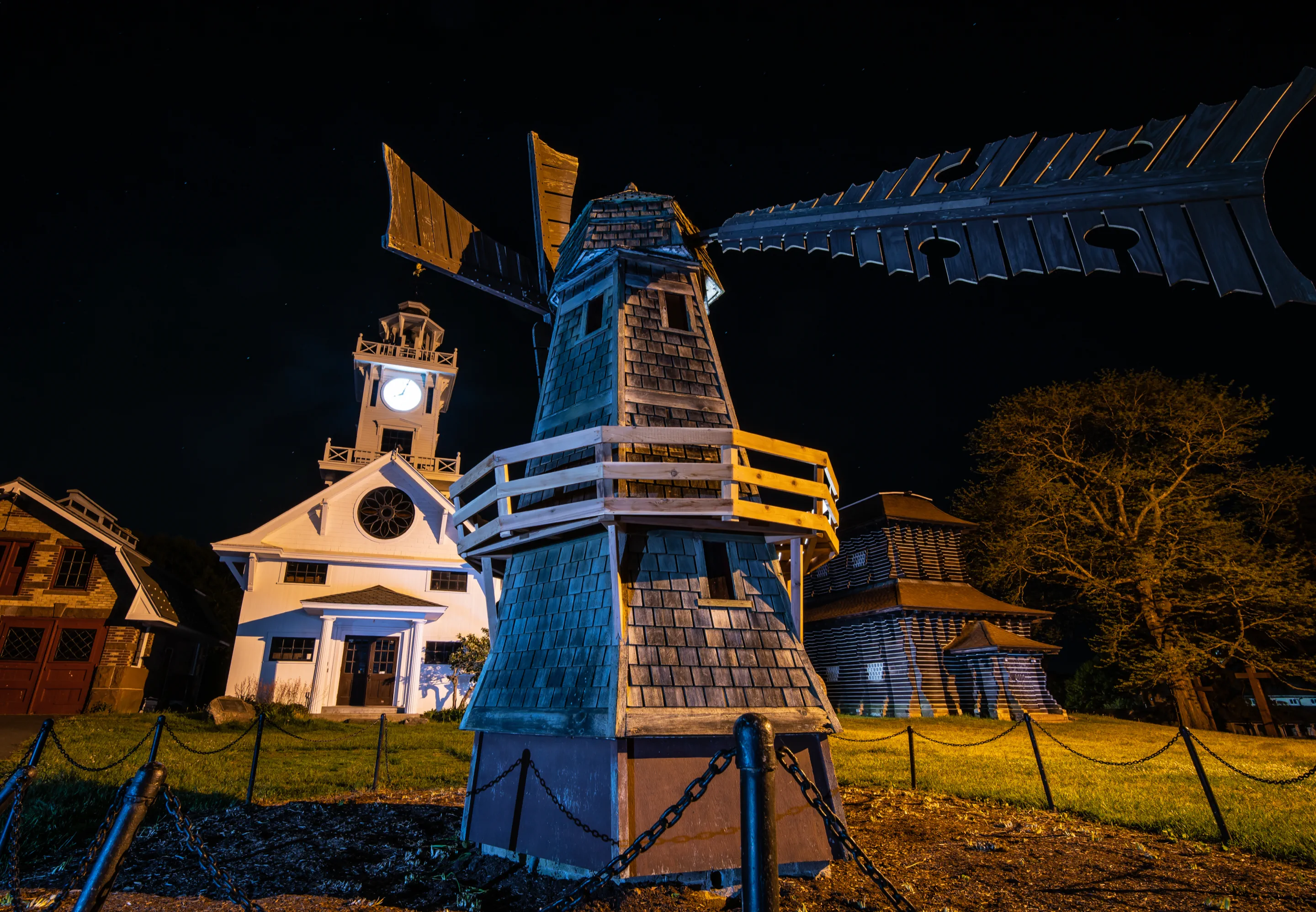 The miniature windmill and Clocktower Museum illuminated against the night sky