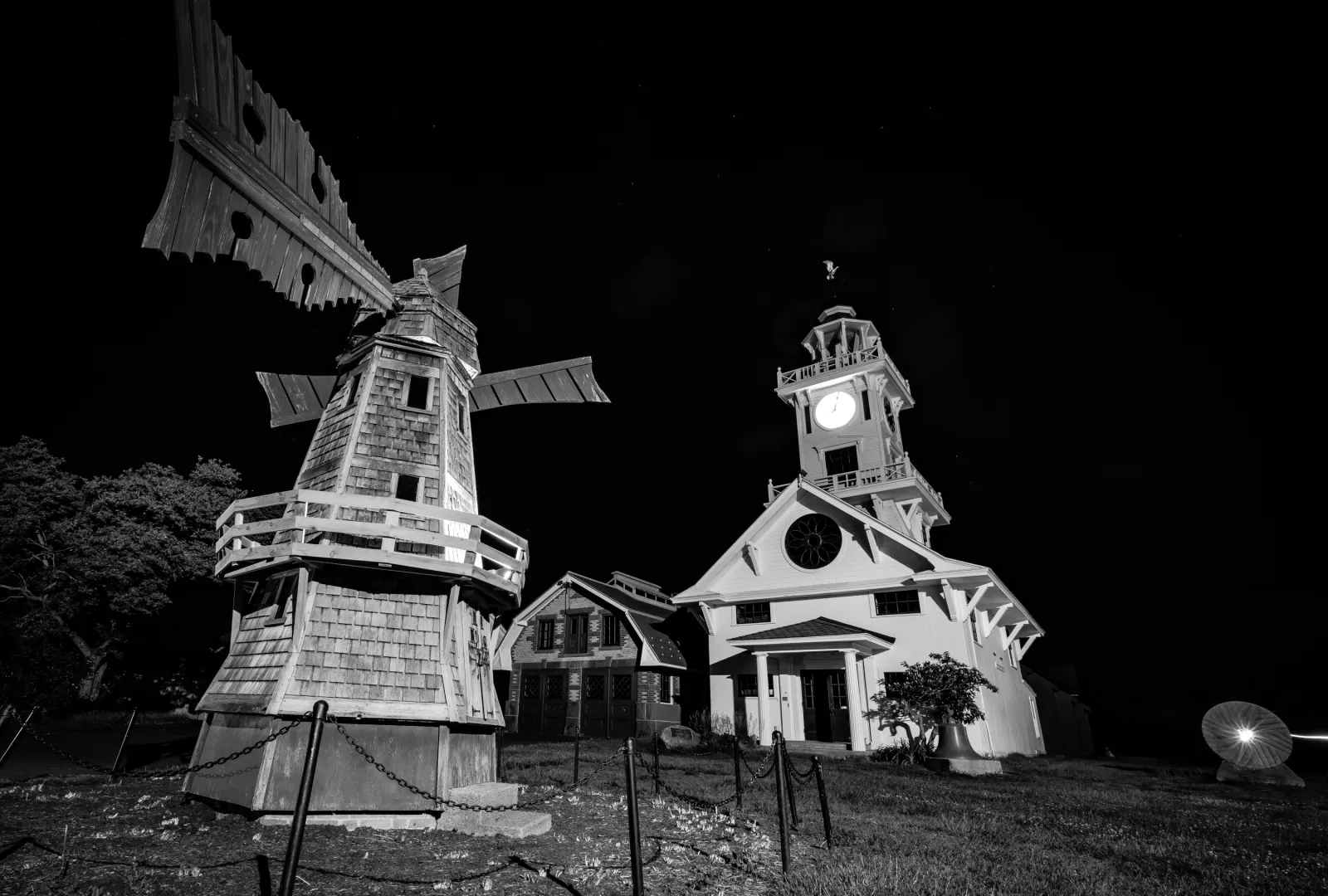 Black-and-white nighttime view of the miniature windmill and Clocktower Museum