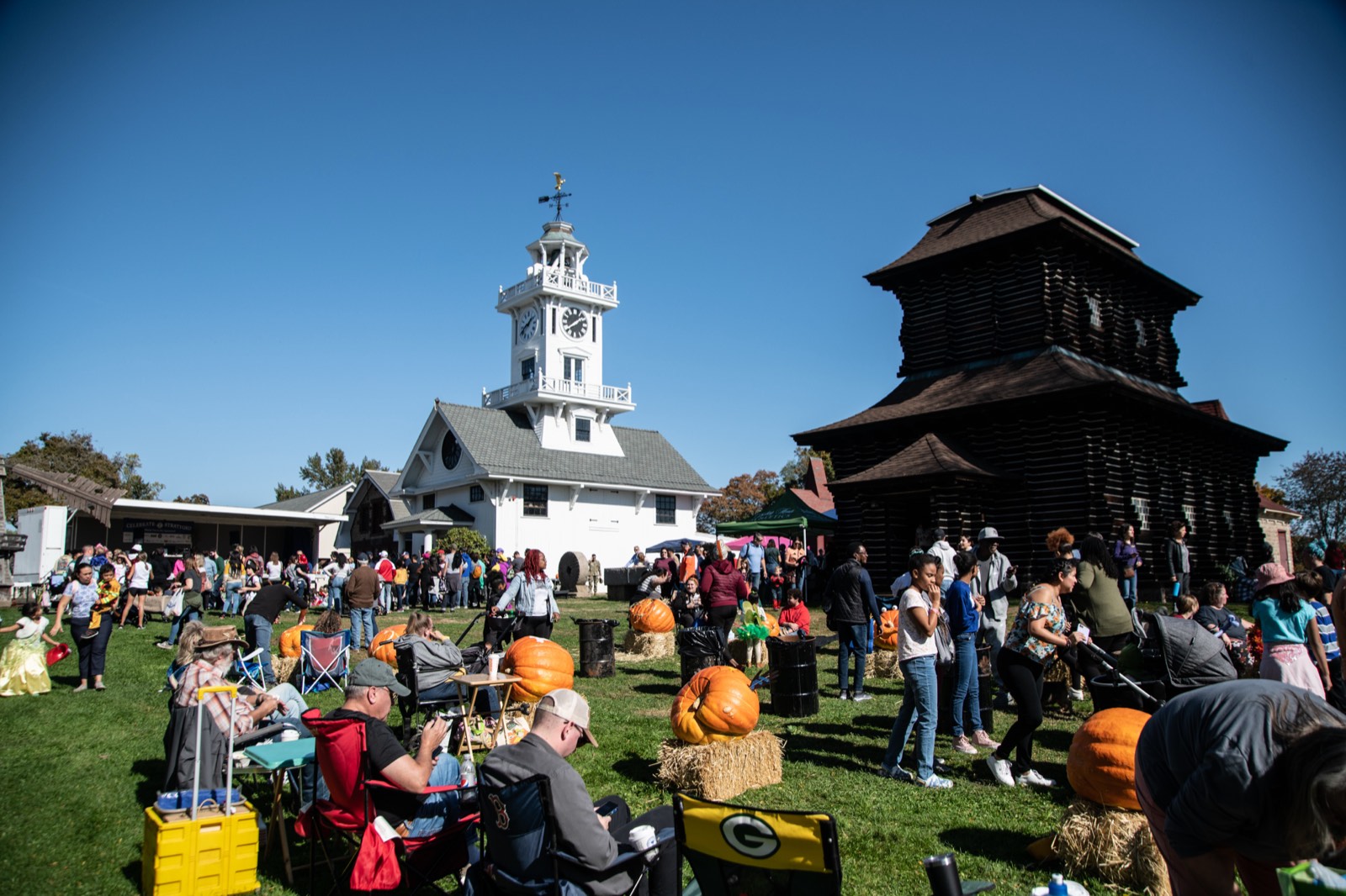 Festival visitors on the lawn between the Clocktower Museum and the Redwood Building